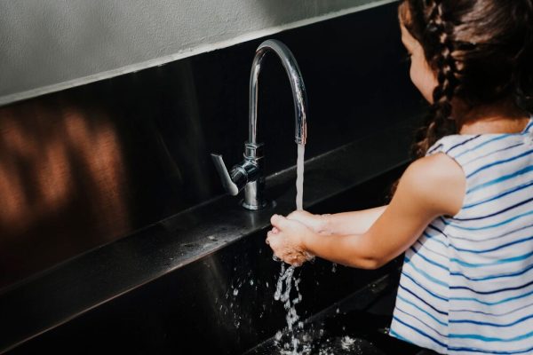 little-girl-washing-her-hands-school_53876-145485